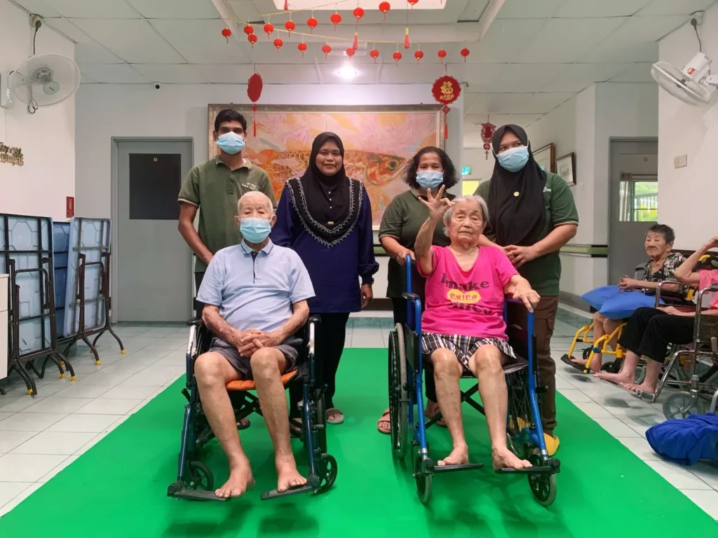 Puan Aziah Binti Abdul (centre left) with residents and the care team at JR Pro Care Centre (JRPC), Kuala Lumpur.